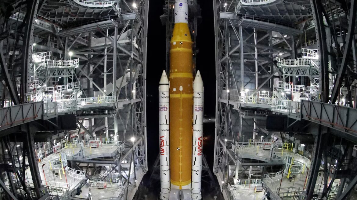NASA hauls repaired moon rocket from hangar back to the pad for an early April launch
